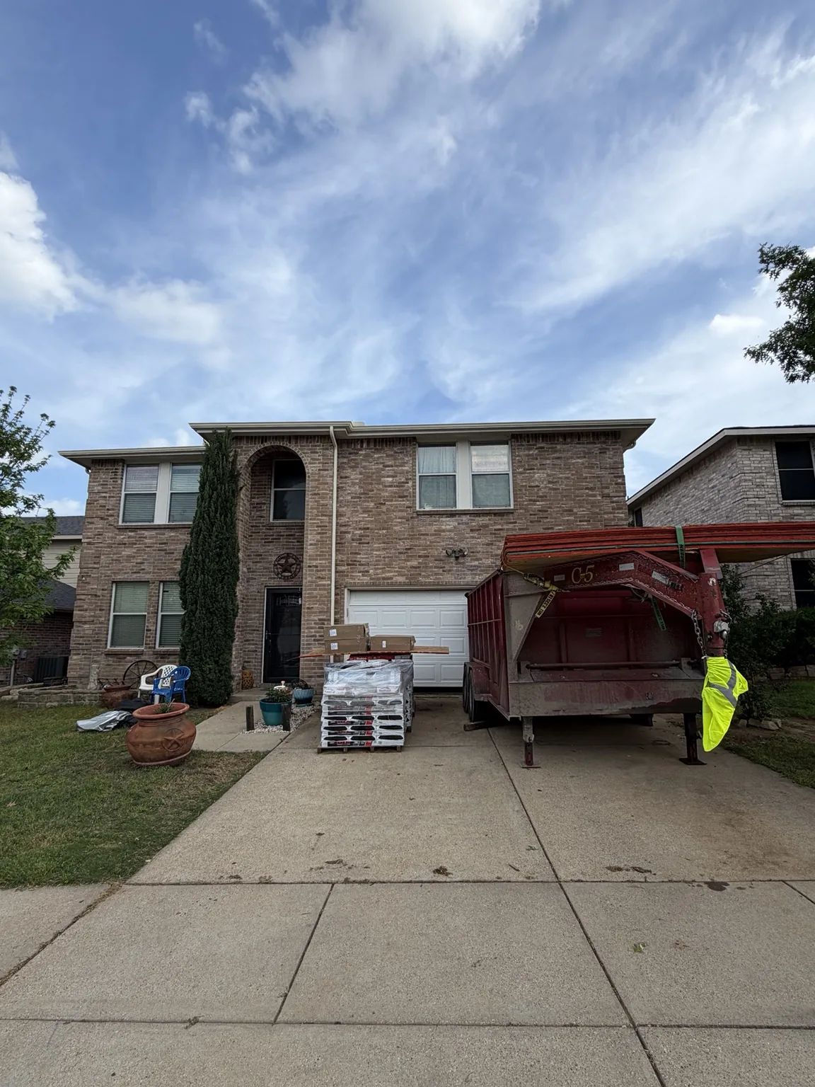 Exterior property with materials staged for restoration work